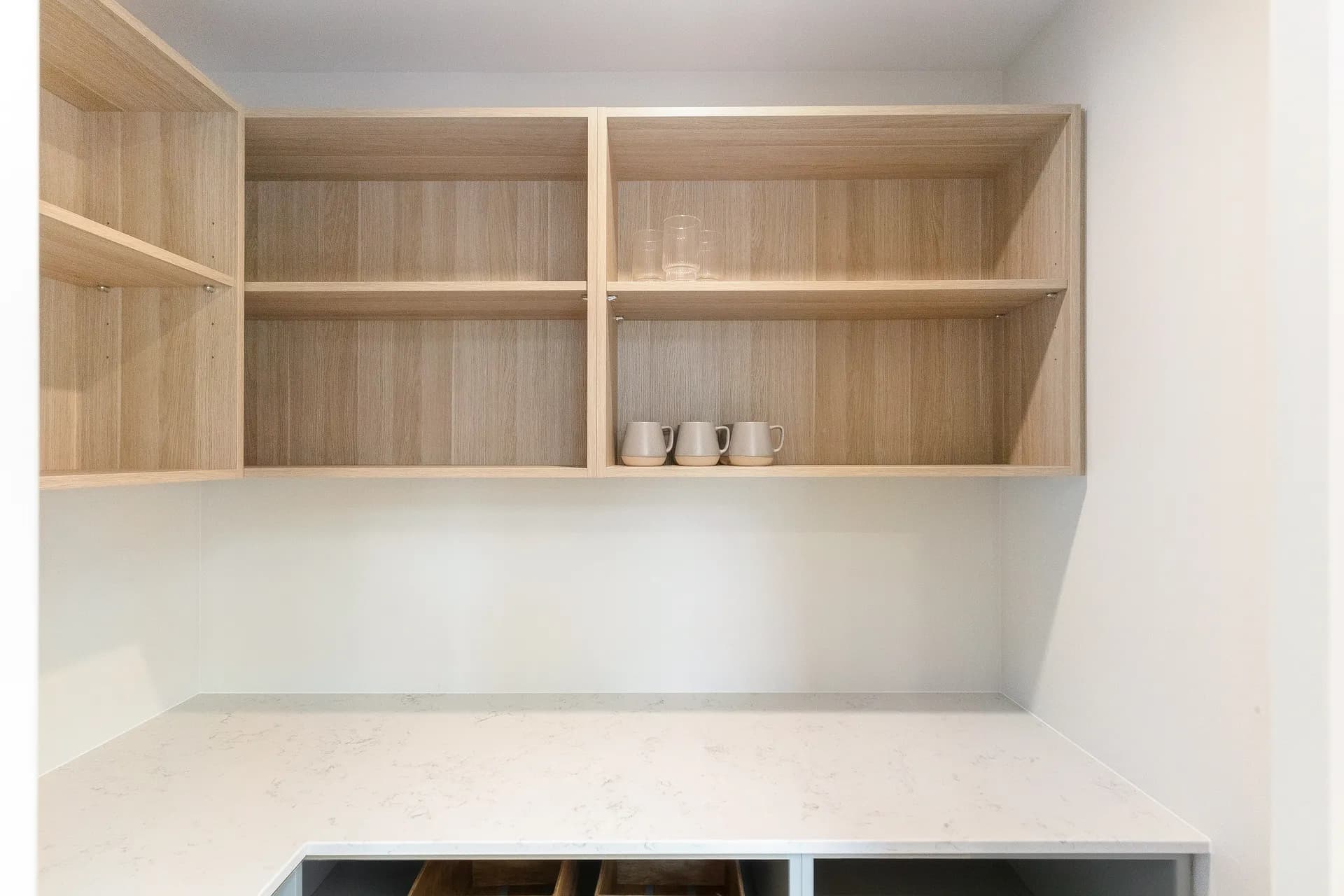 Scullery with timber-look open shelving above a bench