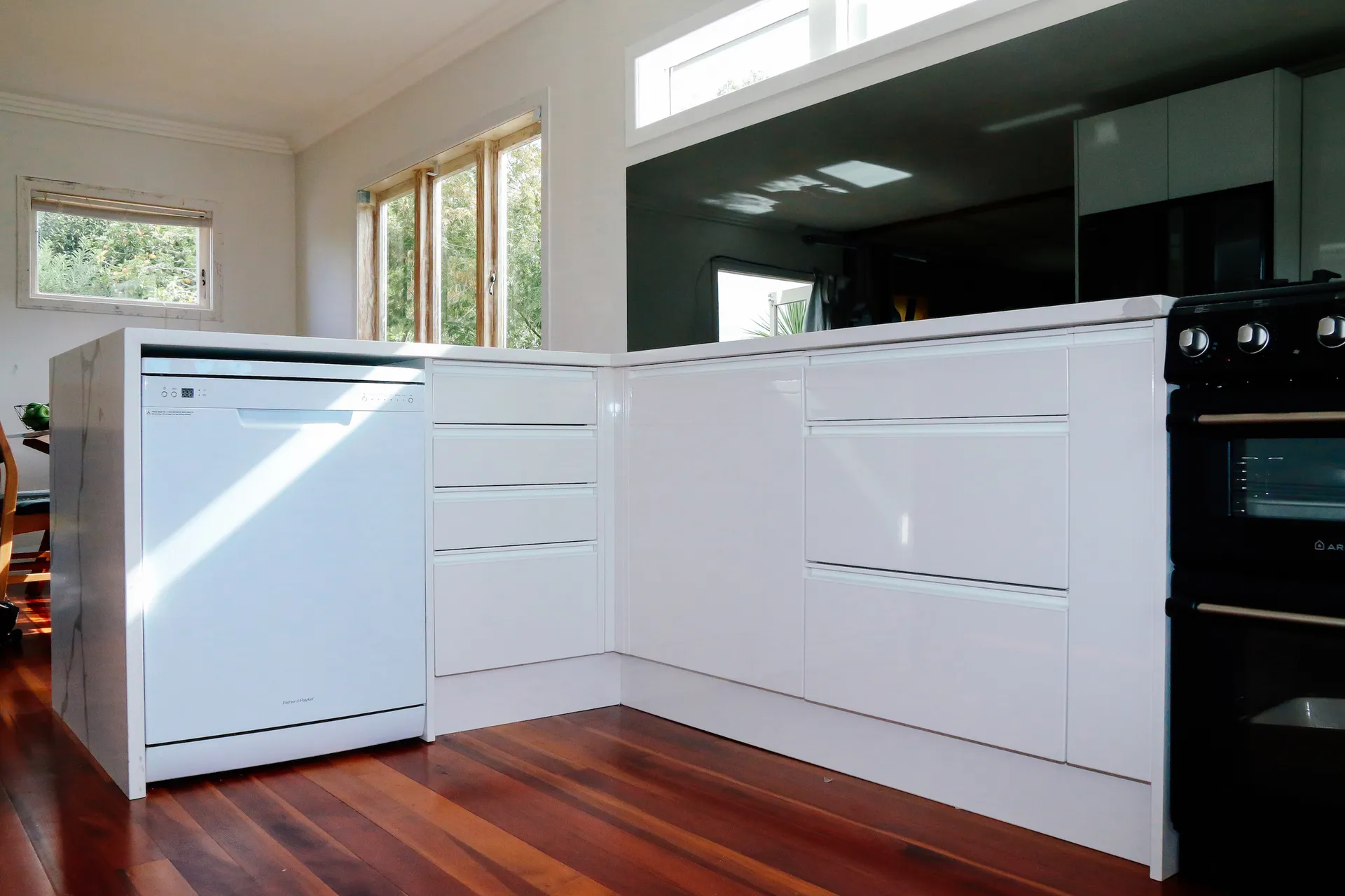 White gloss handleless L-shaped run with a waterfall end