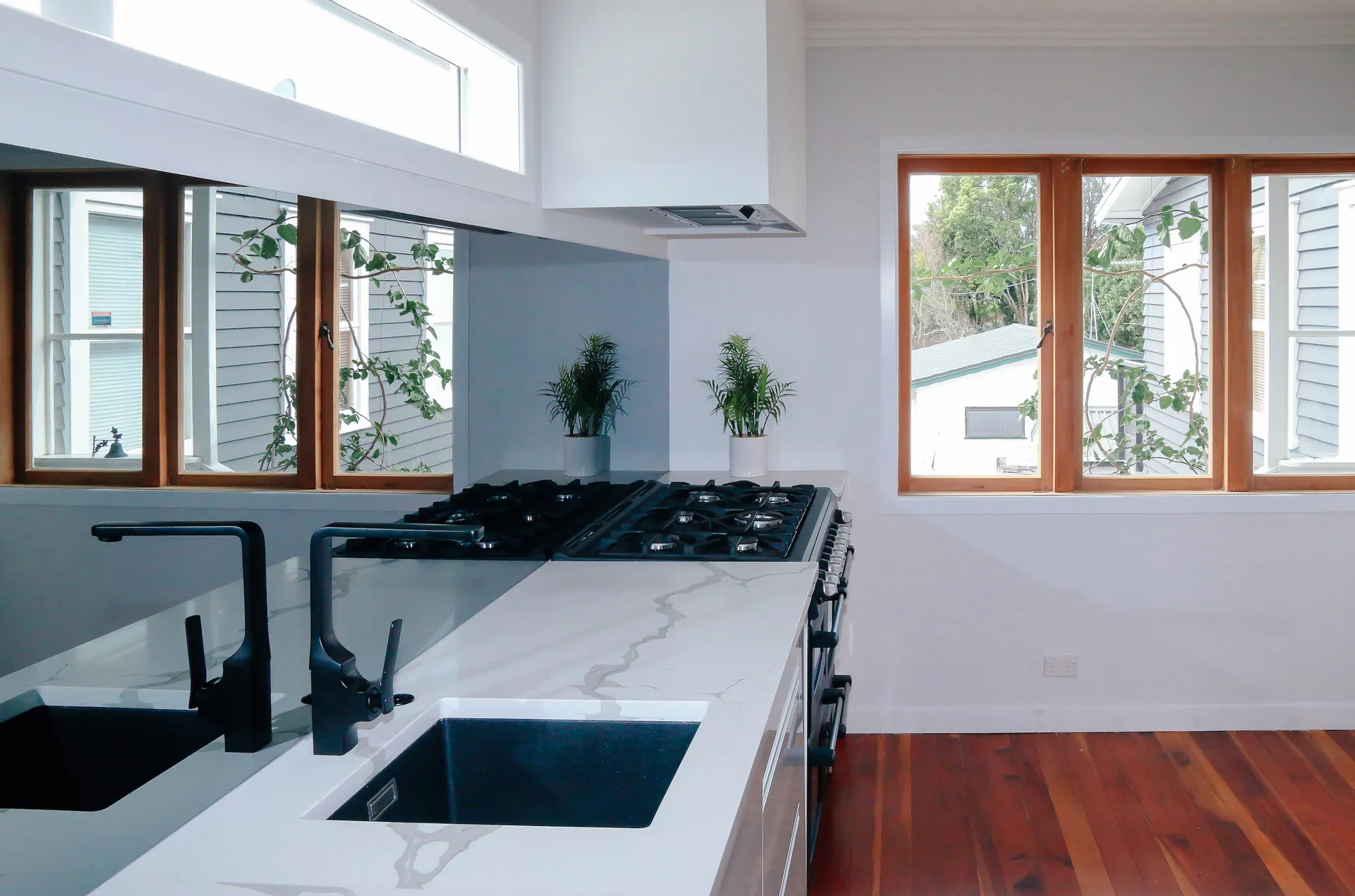Sinks and range set against timber-framed windows