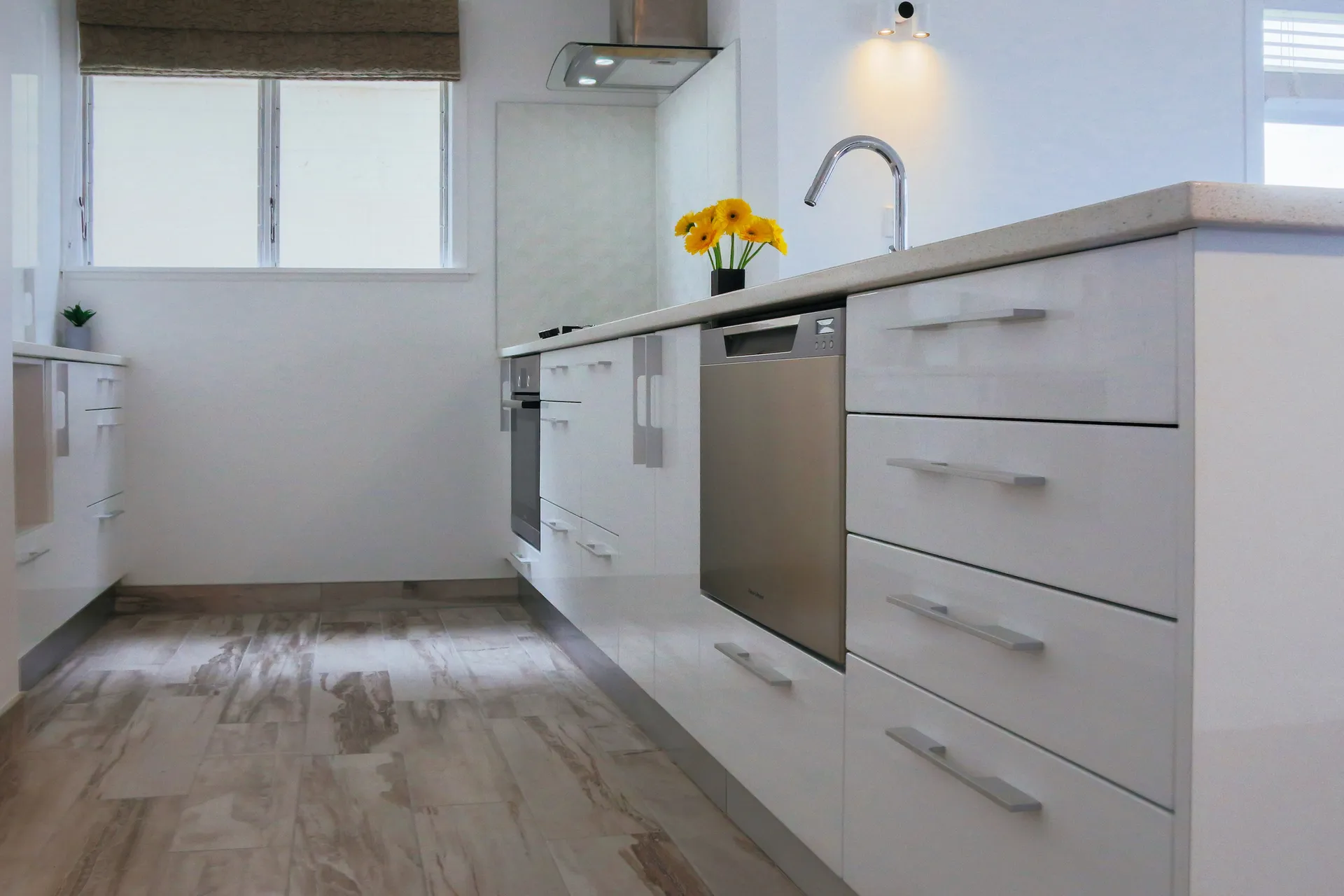 Galley view down a white gloss run with bar handles