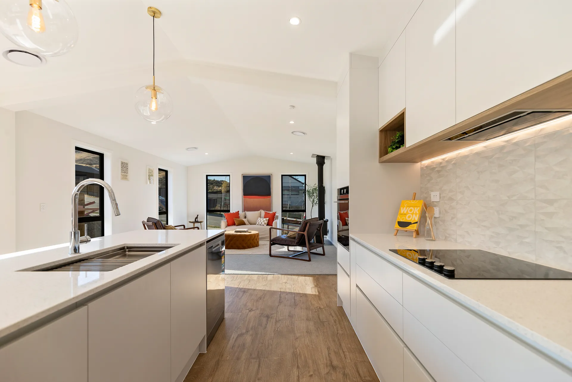 White island sink run and textured tile splashback looking to the living area
