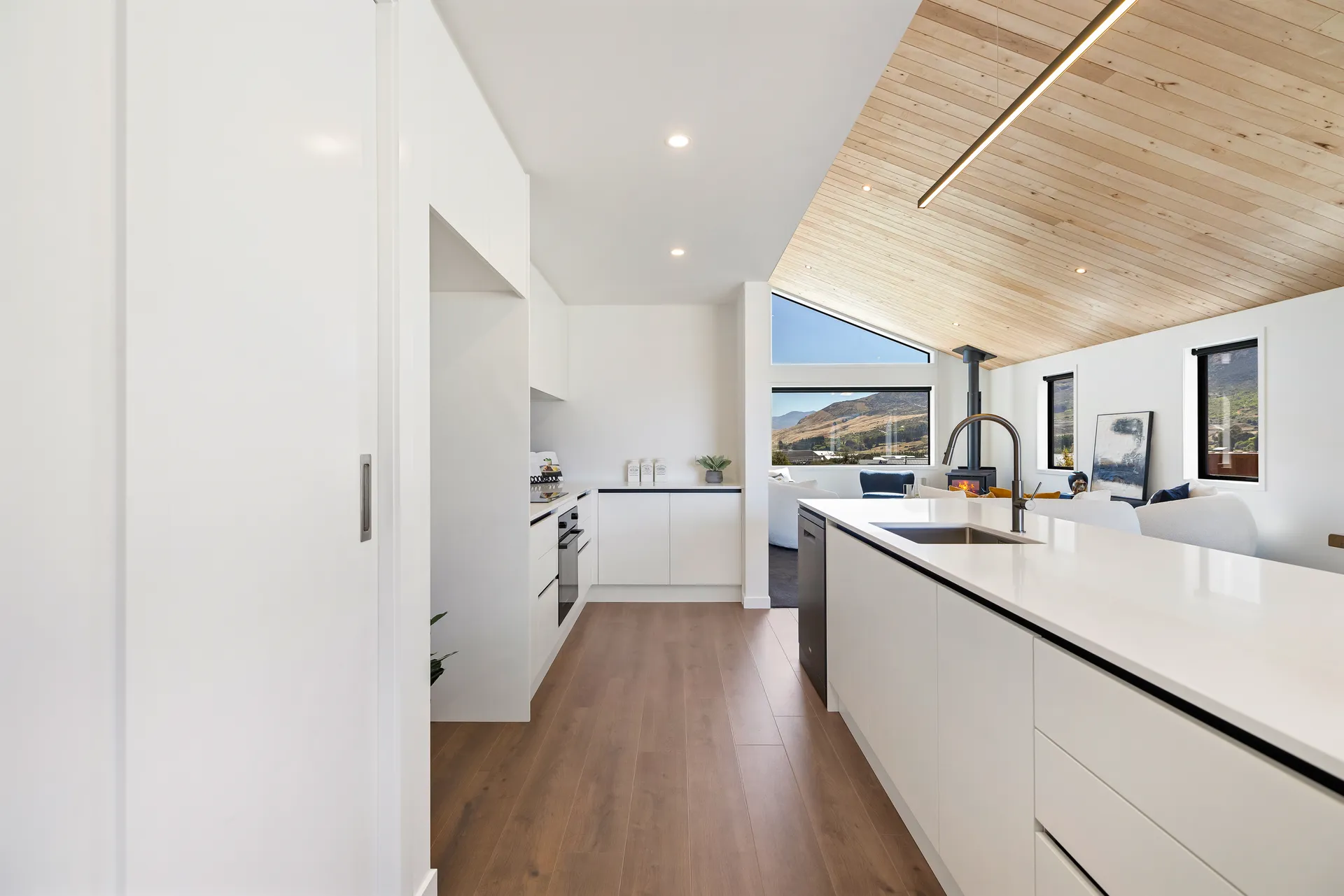 White galley and island looking toward the living area and mountain view