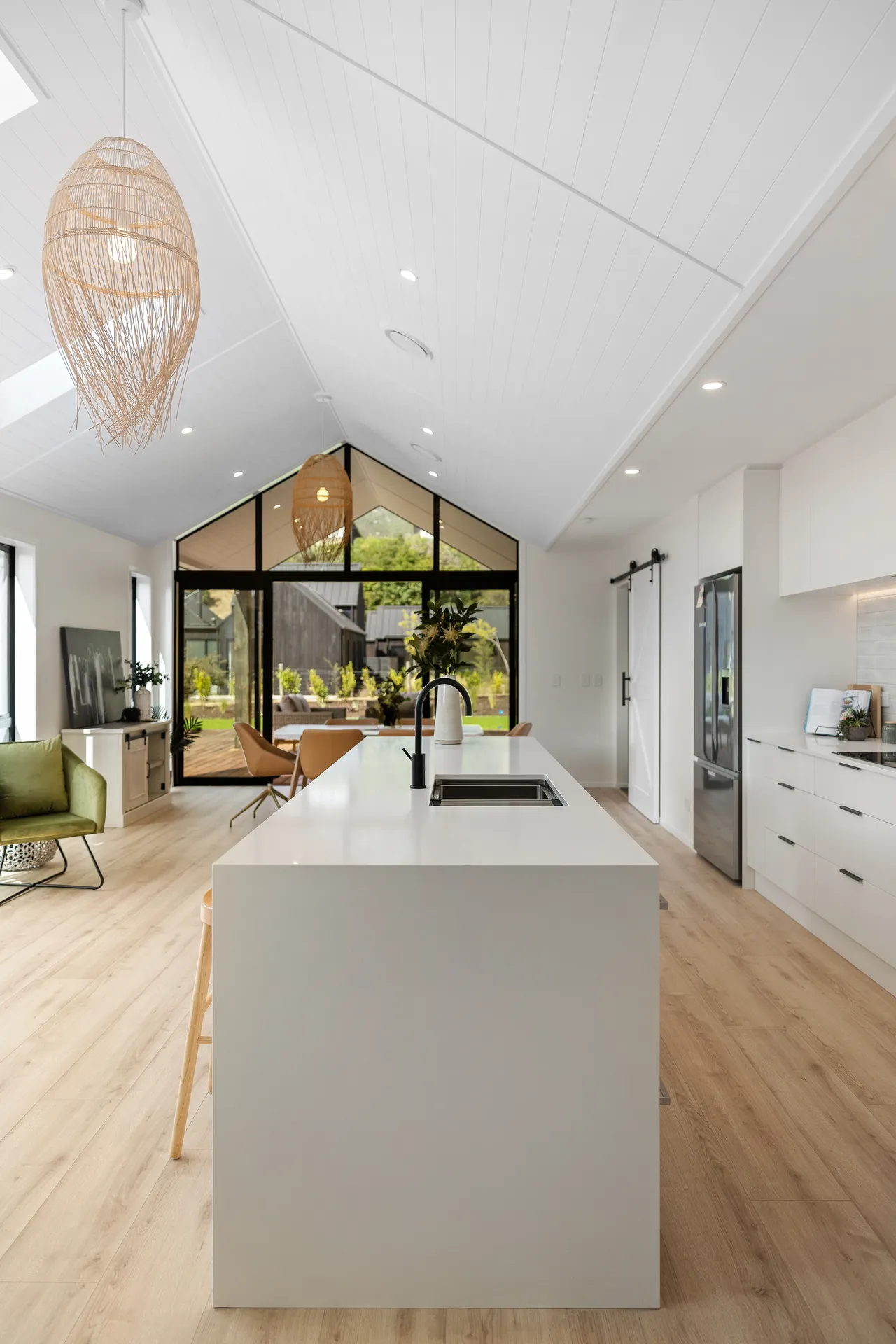 White island down the axis of the room to gable glazing