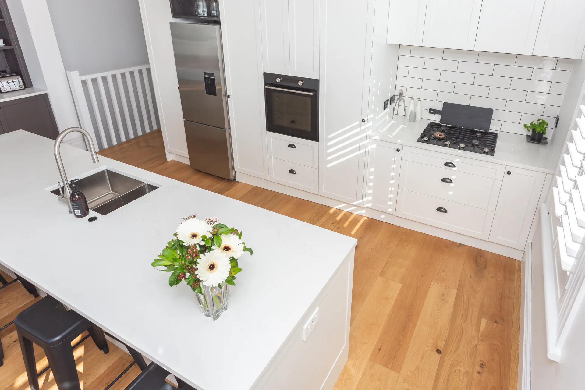 Elevated view over the island to the white shaker back wall