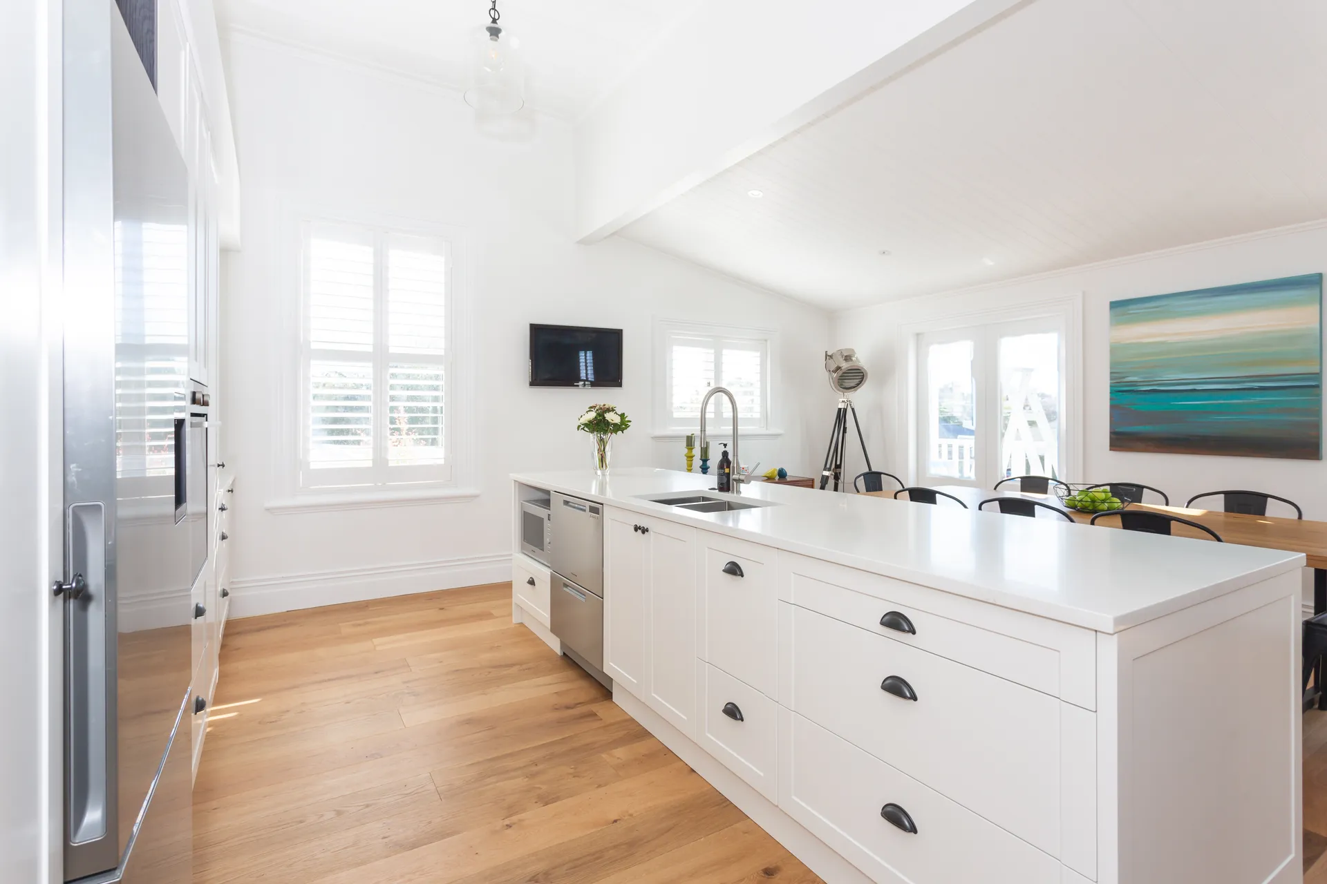 Long white shaker island toward the dining area