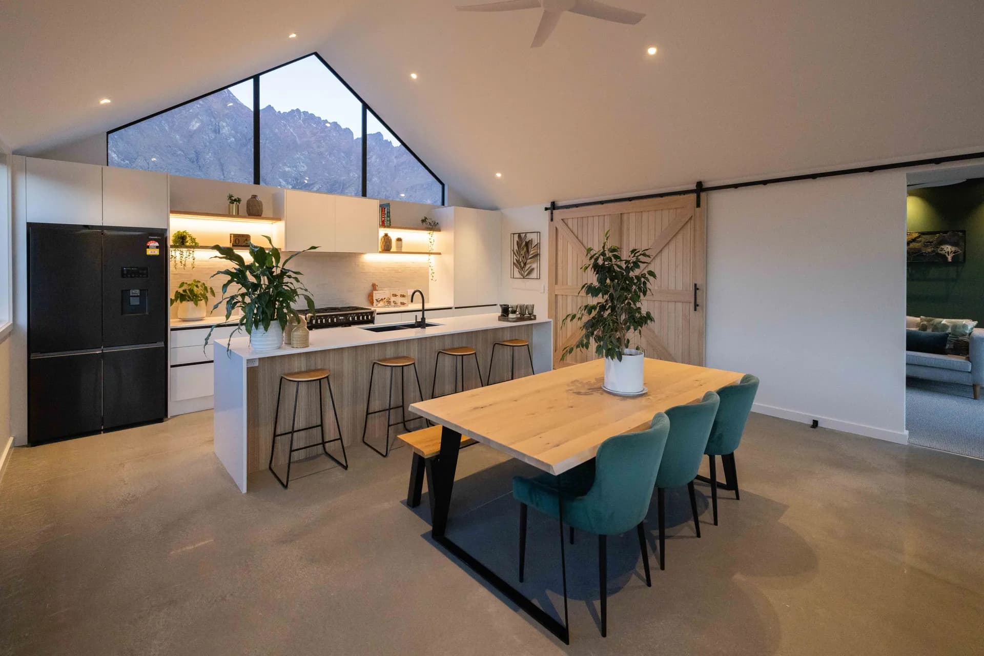 Full kitchen and dining area under a gable window with a mountain view