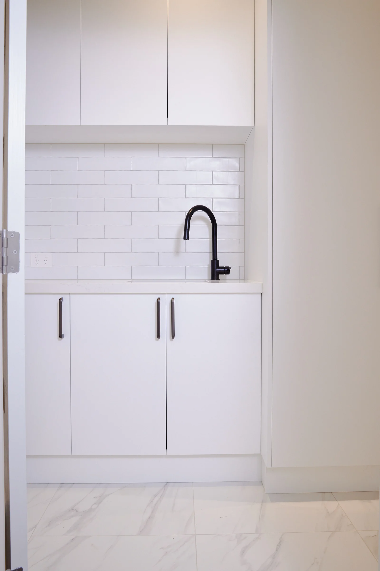 Bespoke laundry design with full-height storage and soft-close drawers, Auckland