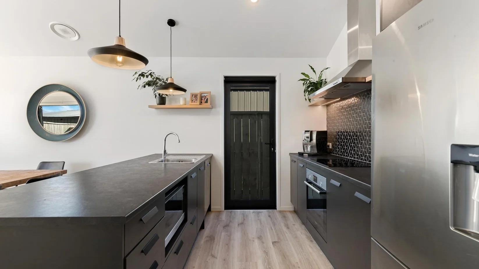 Premium kitchen with waterfall benchtop and full-height splashback, Auckland
