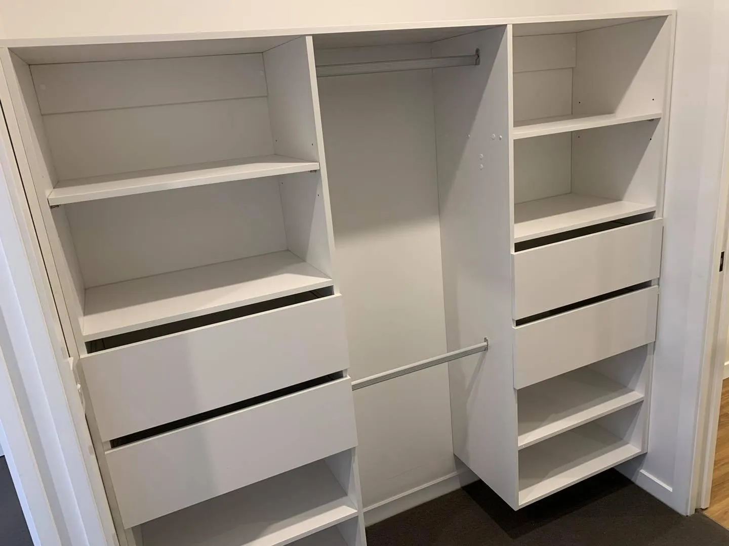 White wardrobe interior with drawers, shelves and hanging rails